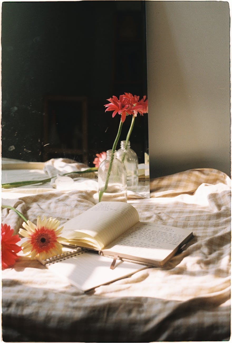 flowers and books on a bed